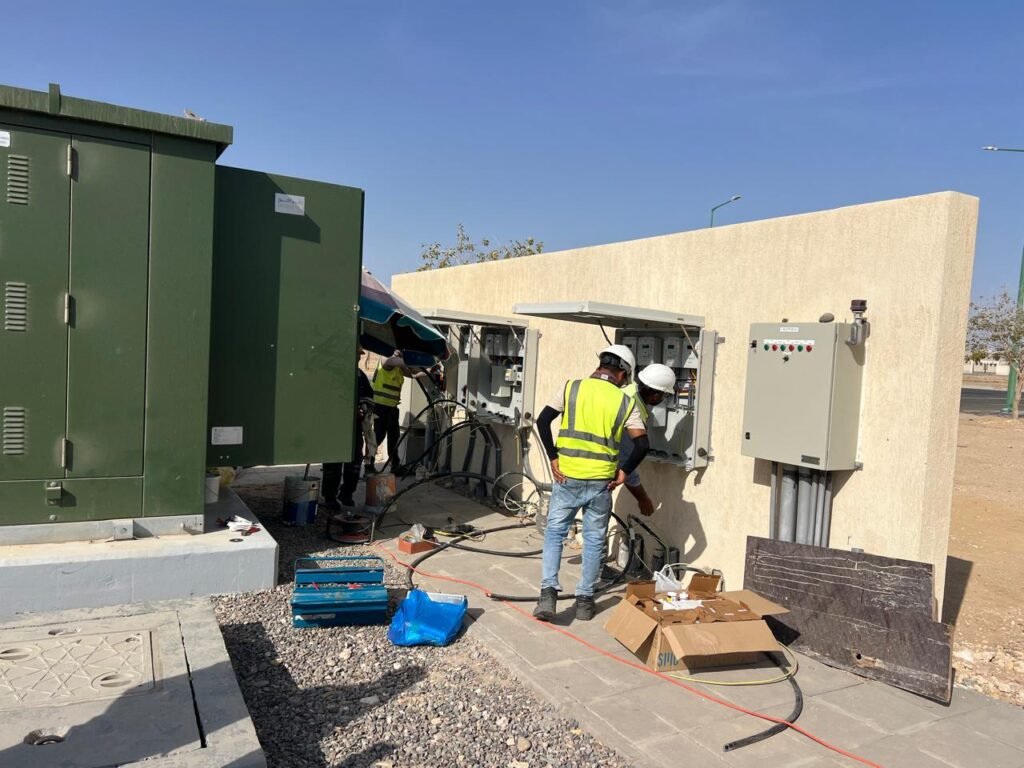 Technicians terminating cables into wall mounted distribution boards
